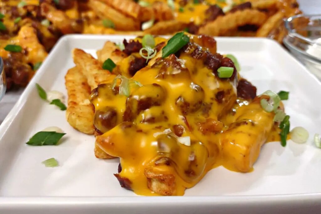 12 Creative Leftover Chili Recipes Loaded crinkle-cut chili cheese fries topped with green onions