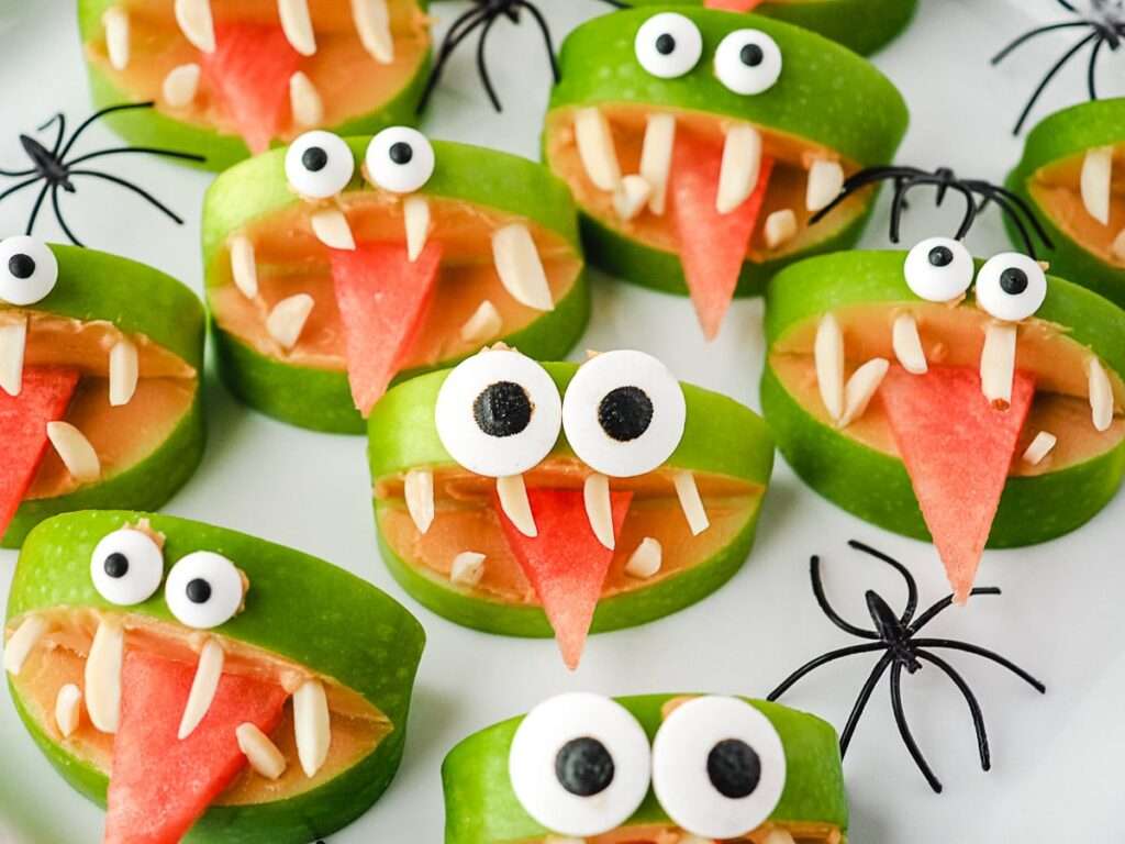 16 Easy & Spooky No Bake Halloween Treats Halloween green apple monster snacks with peanut butter, almond teeth, candy eyes