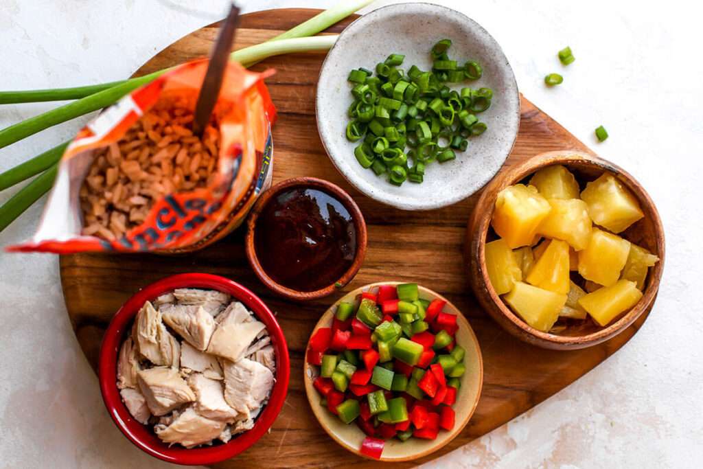 14 Walking Recipes Perfect for Camping Chicken fried rice ingredients: rice, chicken, pineapple, bell peppers, scallions, sauce.