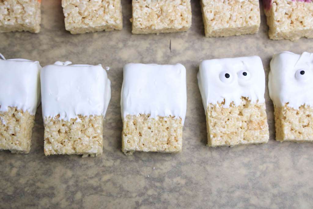 Mummy Rice Krispie treats on parchment paper.