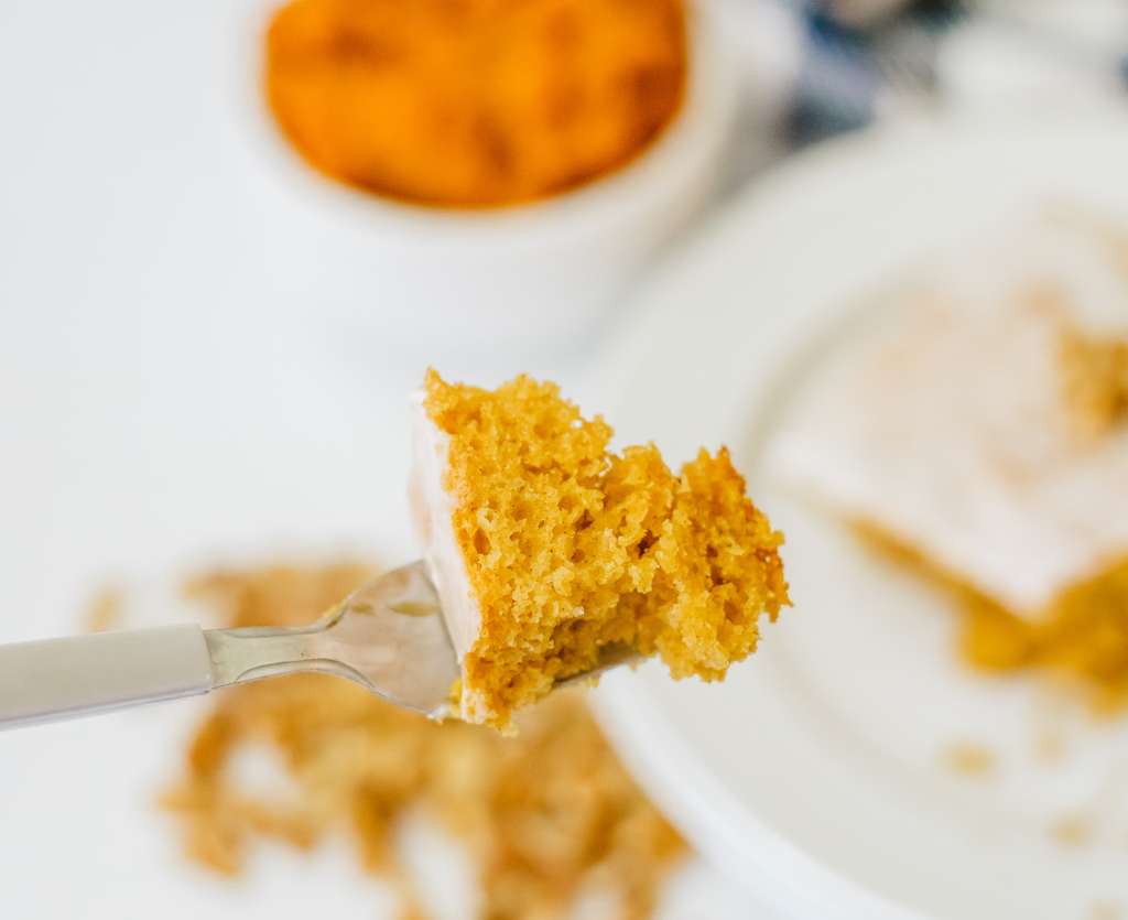 A bit of pumpkin honey bun cake on a fork.