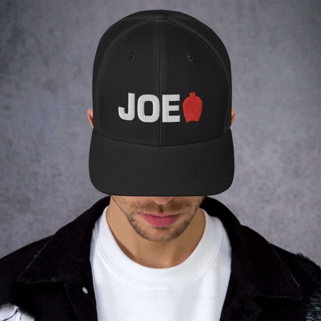 14 Unique Kamado Joe Gifts for Your Grill Master Model wearing black trucker cap with JOE embroidery and red icon