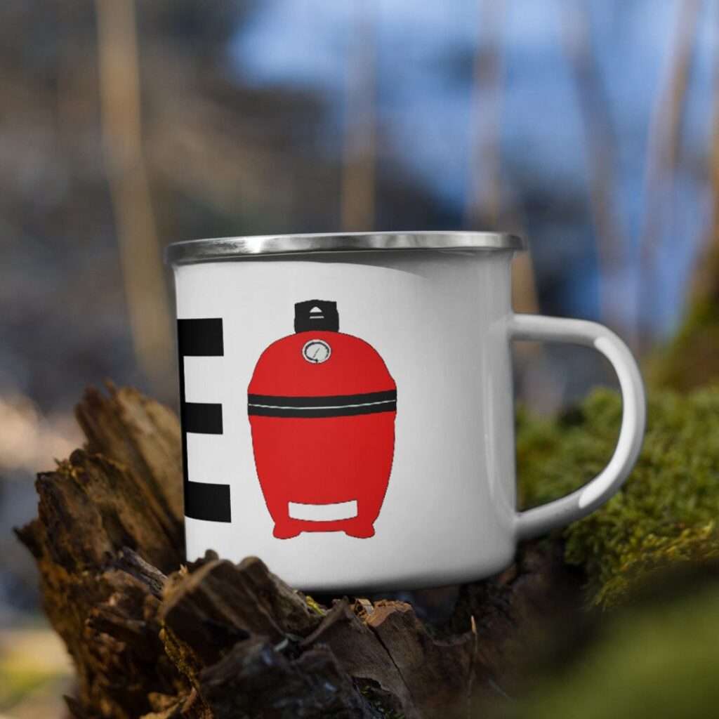 14 Unique Kamado Joe Gifts for Your Grill Master Enamel camping mug with red kamado grill illustration on forest log