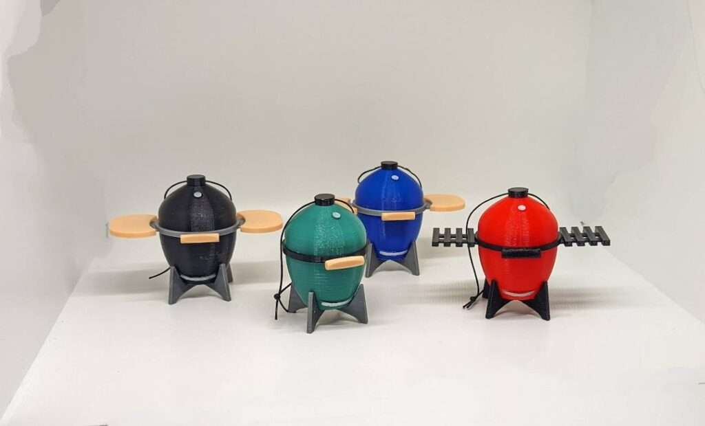 14 Unique Kamado Joe Gifts for Your Grill Master Four colorful mini kamado charcoal grills with side shelves