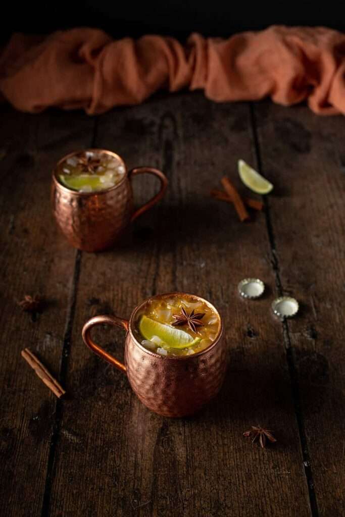 11 Delicious Pumpkin Cocktails to Try This Fall Spiced Moscow Mule cocktails in copper mugs with lime and star anise