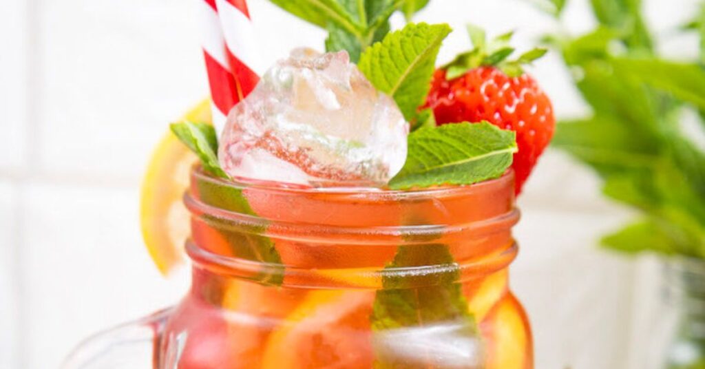 Fresh mint leaves in a strawberry mojito mocktail for the best substitutes for mint.