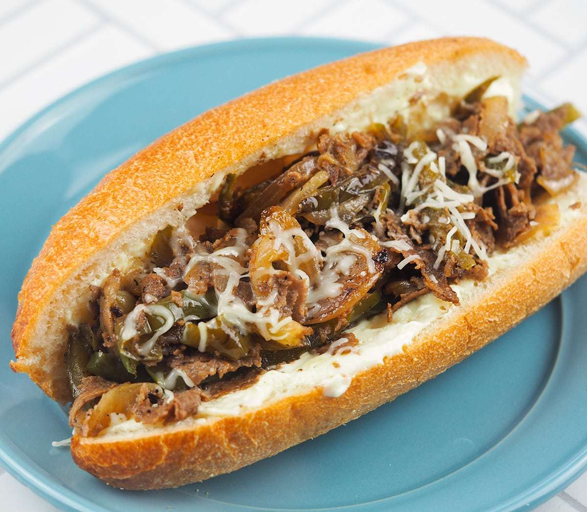 Cheesesteak on a blue plate.