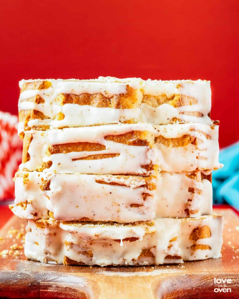8 Traditional Christmas Flavors Close-up of stacked glazed cinnamon bread slices on a cutting board