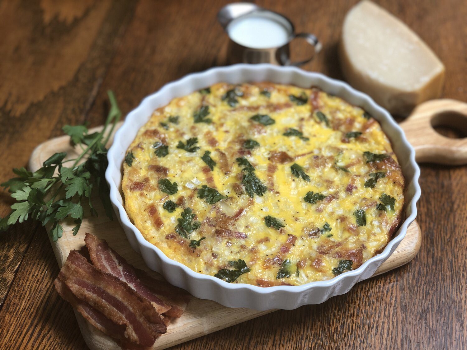 A quiche dish filled with bacon crustless quiche.