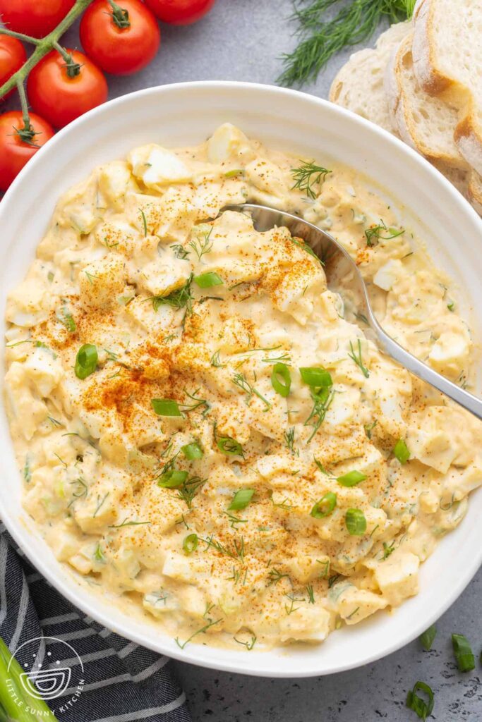 A white plate of egg salad.