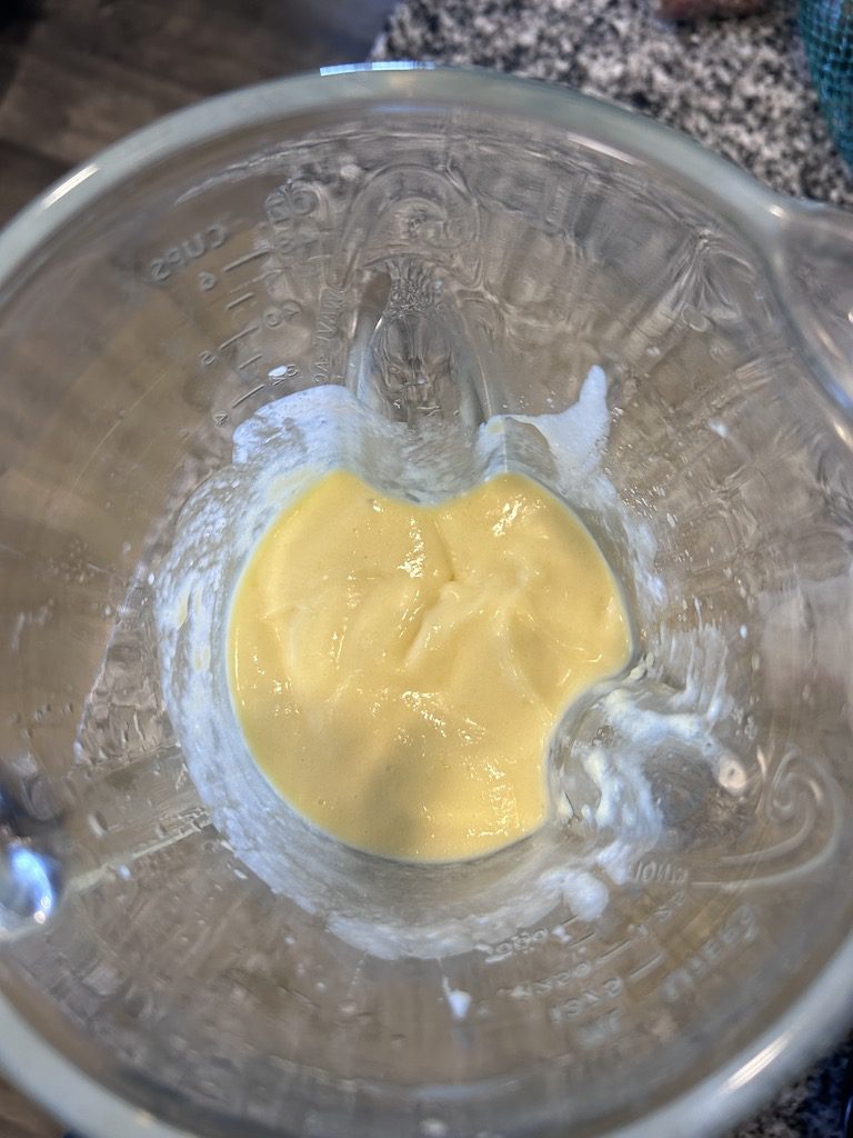 The mango mixture for cherry mango popsicles in a blender.