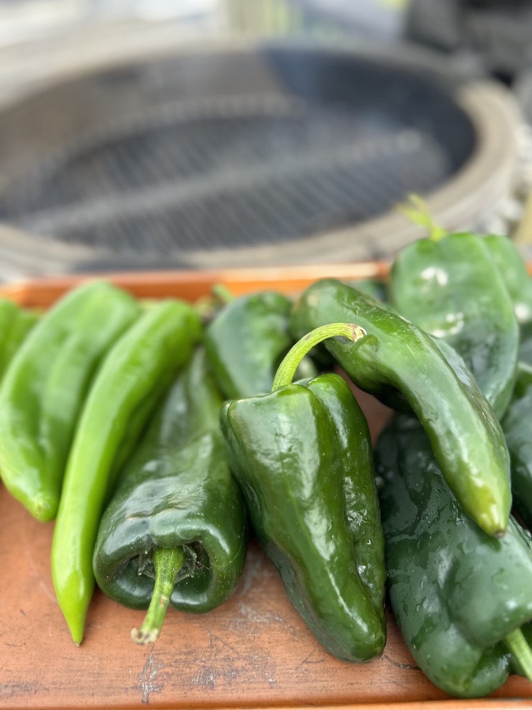 Anaheim and poblano peppers ready to go on the Kamado Joe grill to be roasted.