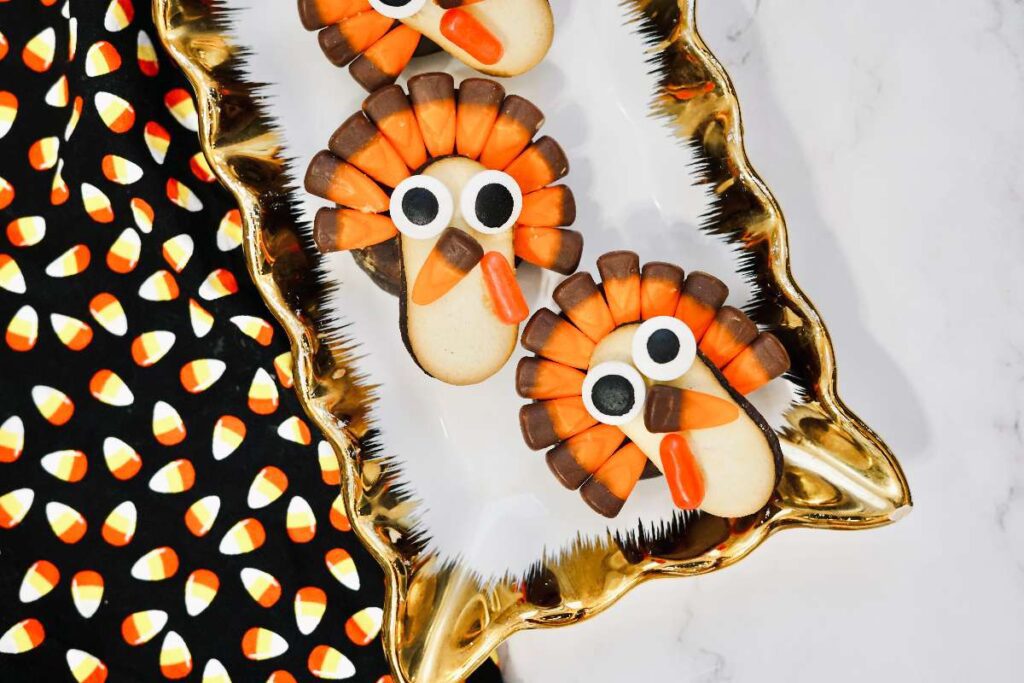 8 Delectable Turkey Desserts for Thanksgiving Thanksgiving candy corn turkey cookies on gold platter