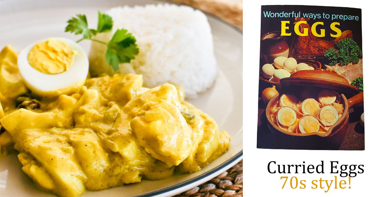 A white plate with curried eggs and a side of a half a hard boiled egg and a scoop of rice garnished with fresh parsley.