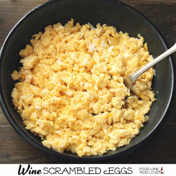 A black dish filled with win scrambled eggs.
