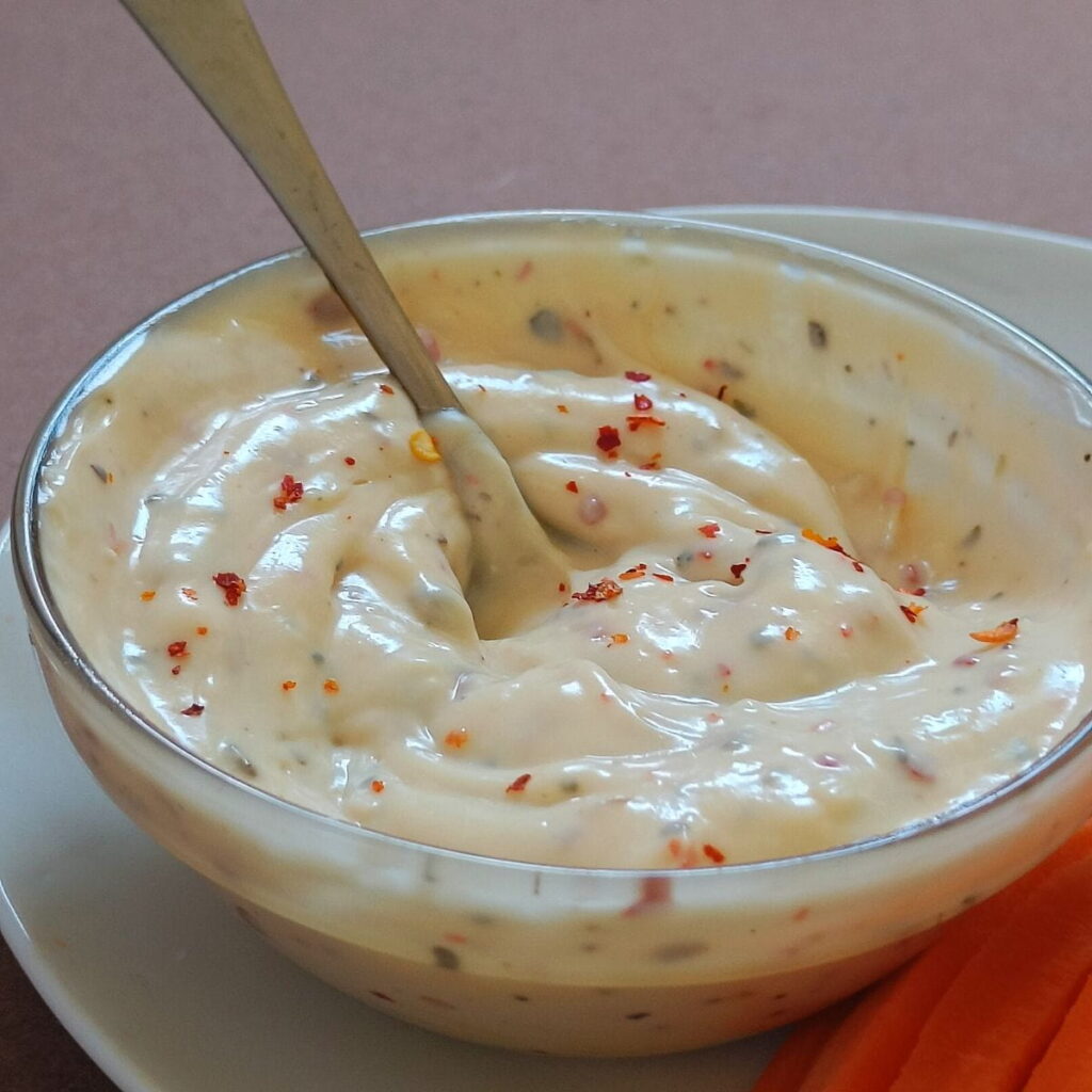 8 Irresistible Buffalo Wild Wings Copycat Recipes Spicy mayo dip with chili flakes in a glass bowl with spoon and carrot sticks