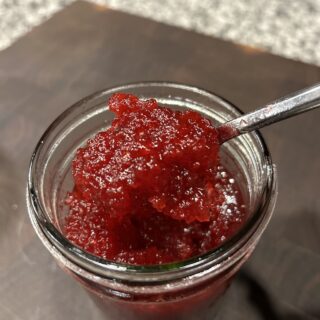 A spoonful of Christmas Jam being spooned out.