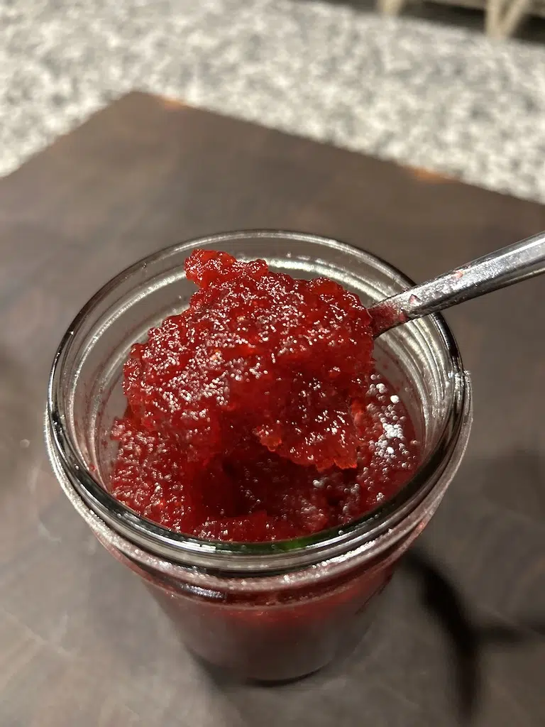 A spoonful of Christmas Jam being spooned out.