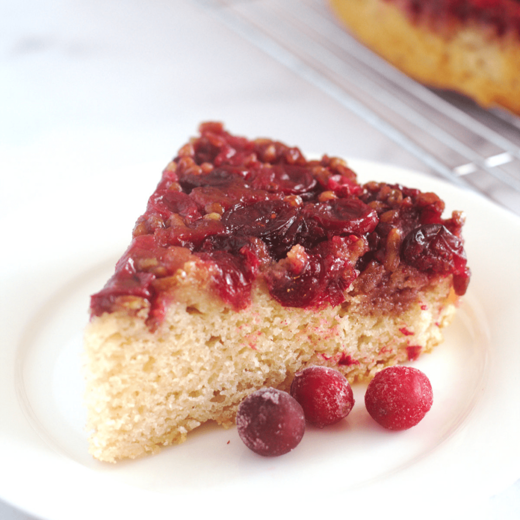 Cranberry upside-down cake slice with fresh cranberries