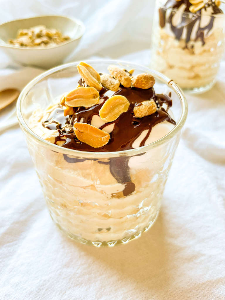A serving of sugar free peanut butter chocolate mousse in a parfait glass.