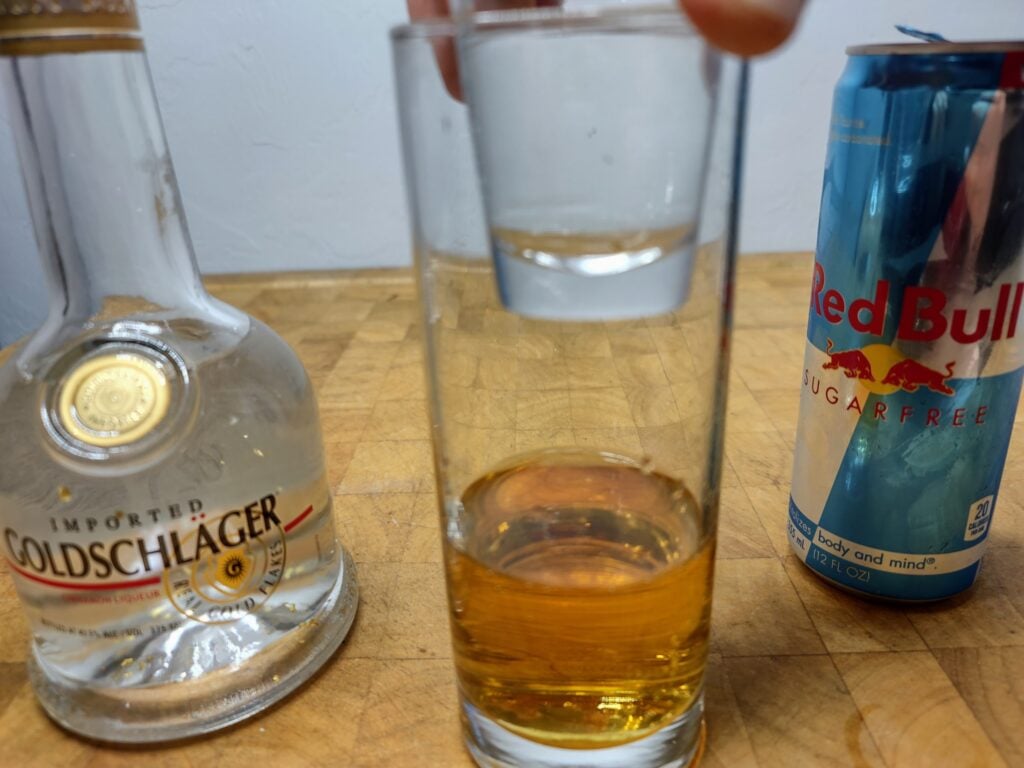 6 New Year's Eve Shots Goldschlager cinnamon liqueur and sugar-free Red Bull with a shot glass