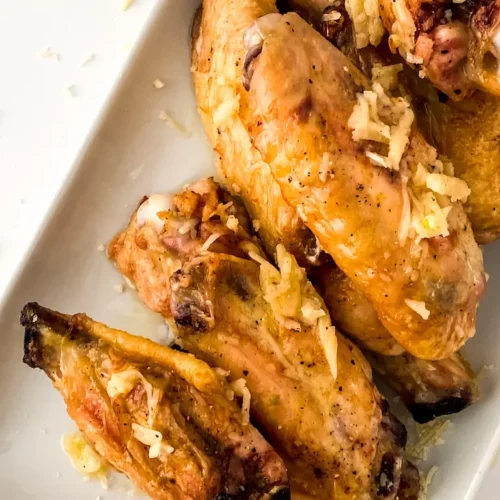 Oven-baked garlic parmesan wings on a white plate
