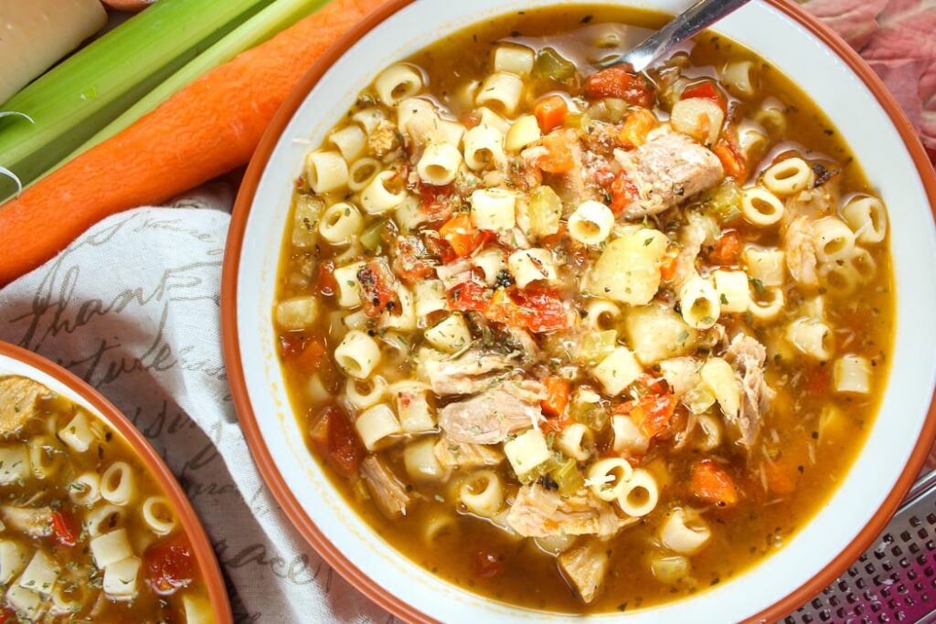 Bowl of hearty chicken ditalini pasta soup with vegetables in rich broth