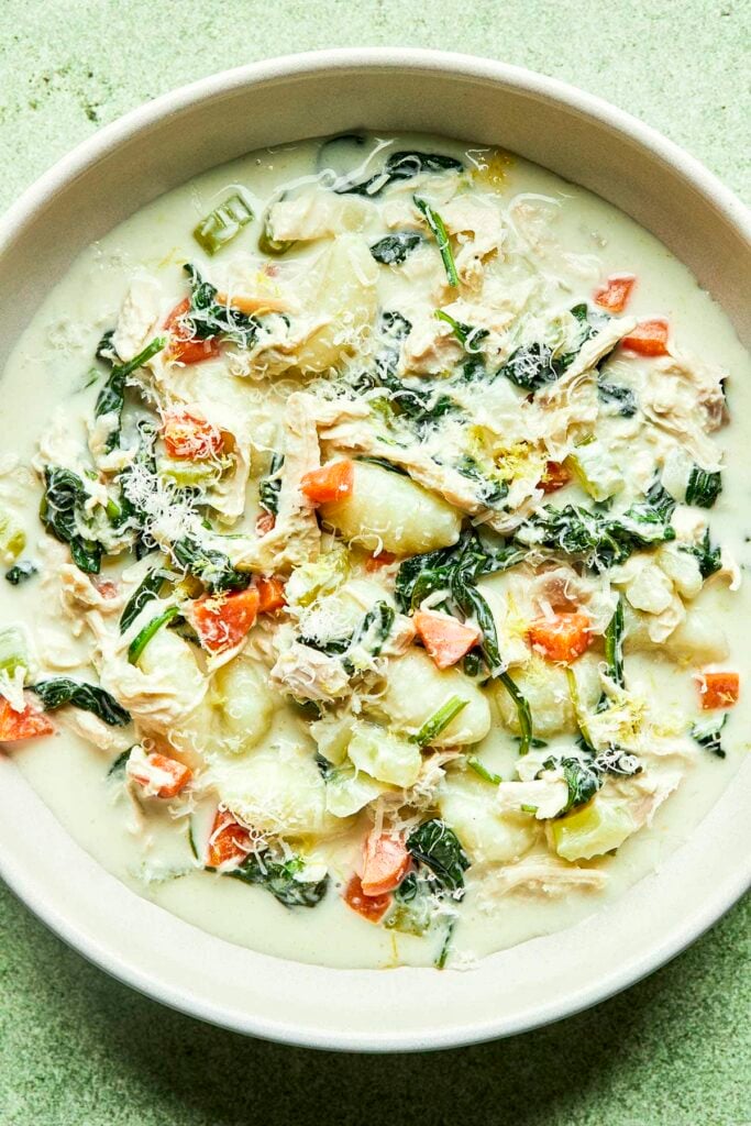Creamy chicken gnocchi soup with spinach, carrots, and Parmesan.