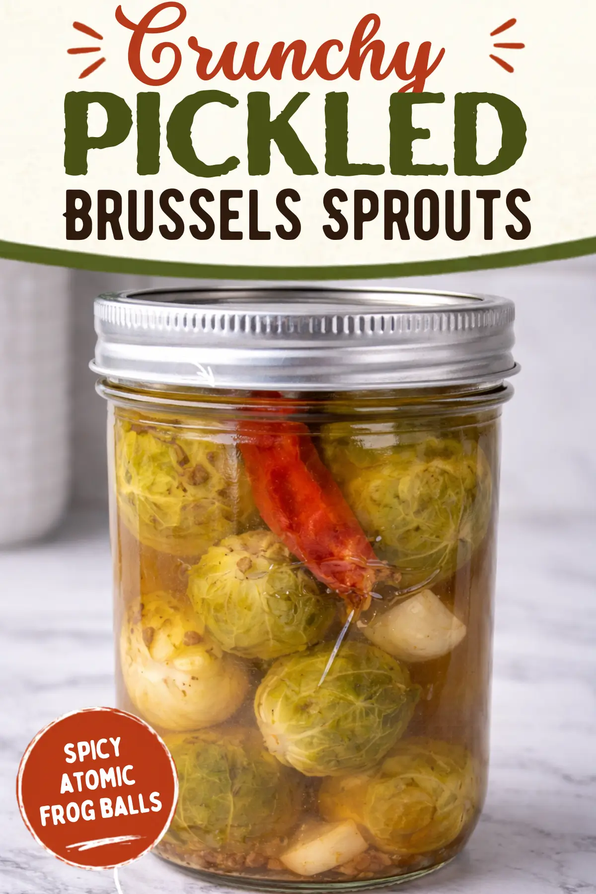 Crunchy pickled Brussels sprouts in a mason jar with chili pepper and garlic cloves