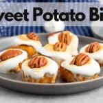 Sweet potato rounds with marshmallows and pecans on a gray plate