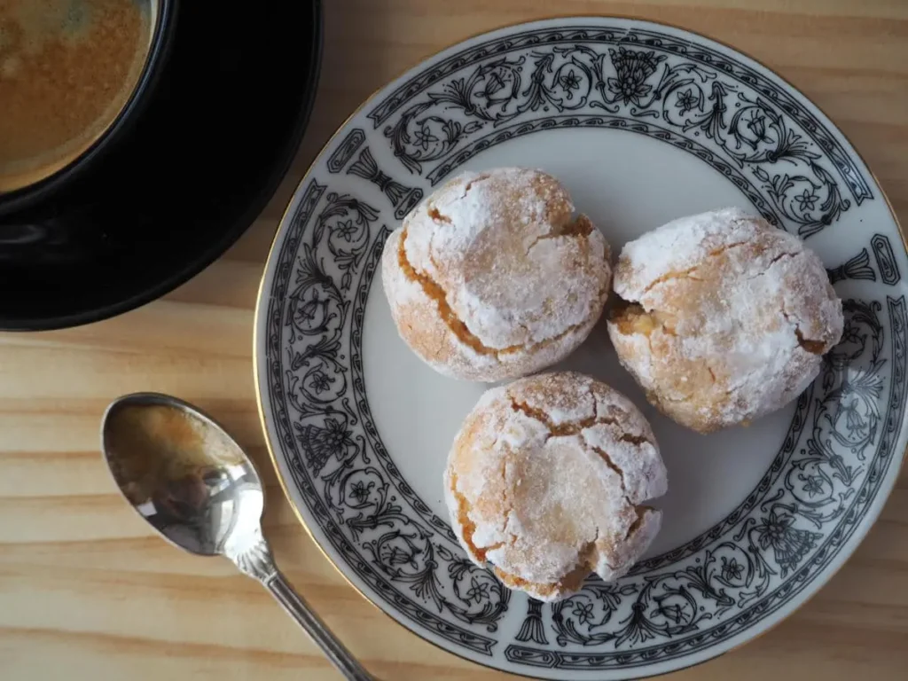 Freshly baked Amaretti Cookies dusted with powdered sugar, perfect for tea-time or a festive holiday treat. Made with gluten free cookies using almond flour, they offer a chewy texture and a nutty flavor, ideal for anyone searching for good almond flour recipes.