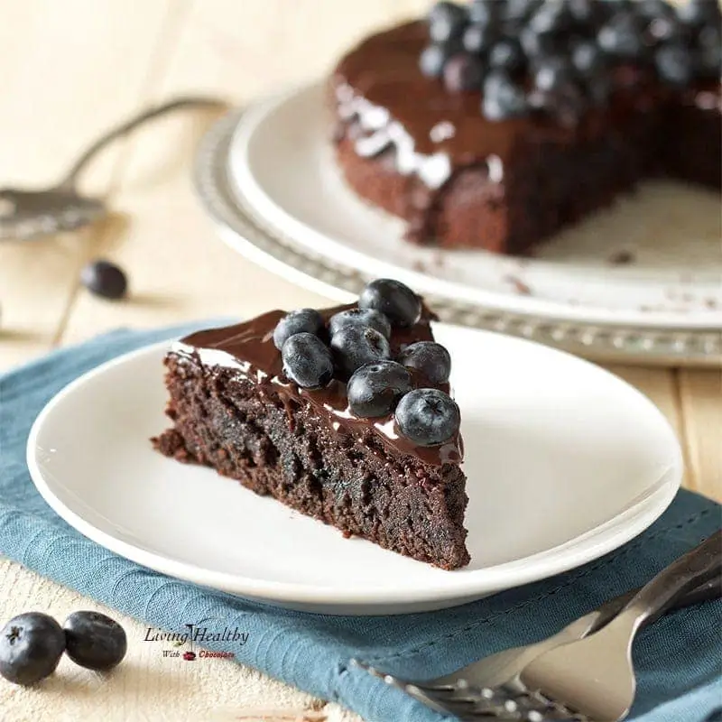 A rich and fudgy blueberry chocolate cake topped with fresh blueberries. This paleo and gluten-free dessert combines the sweetness of chocolate with a fruity twist.