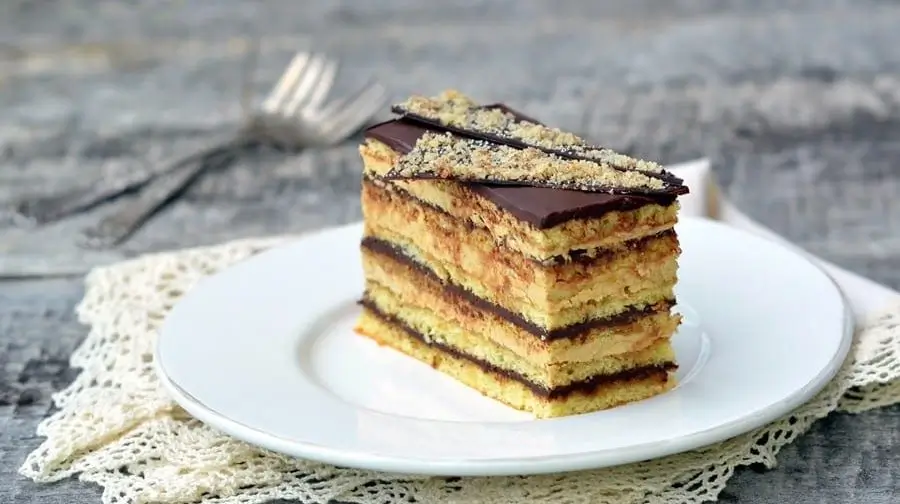 Classic French Opera Cake with almond sponge layers soaked in coffee syrup and topped with chocolate ganache, a gluten-free delight.