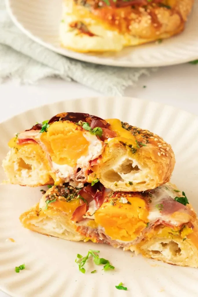 Bagel breakfast sandwich featuring egg, prosciutto, and garlic butter, perfect for brunch or meal prep.