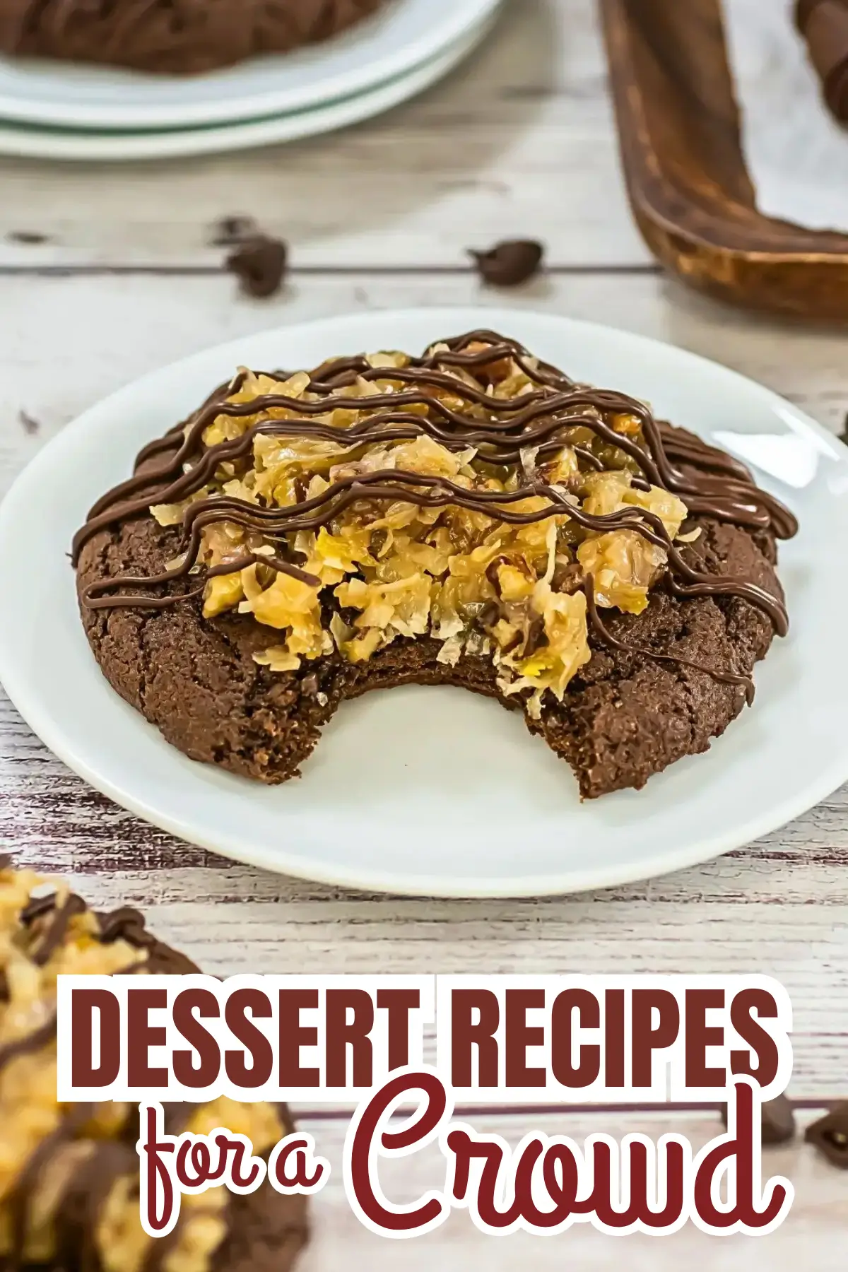 Close-up chocolate cookie topped with coconut-pecan caramel and chocolate drizzle, bite taken