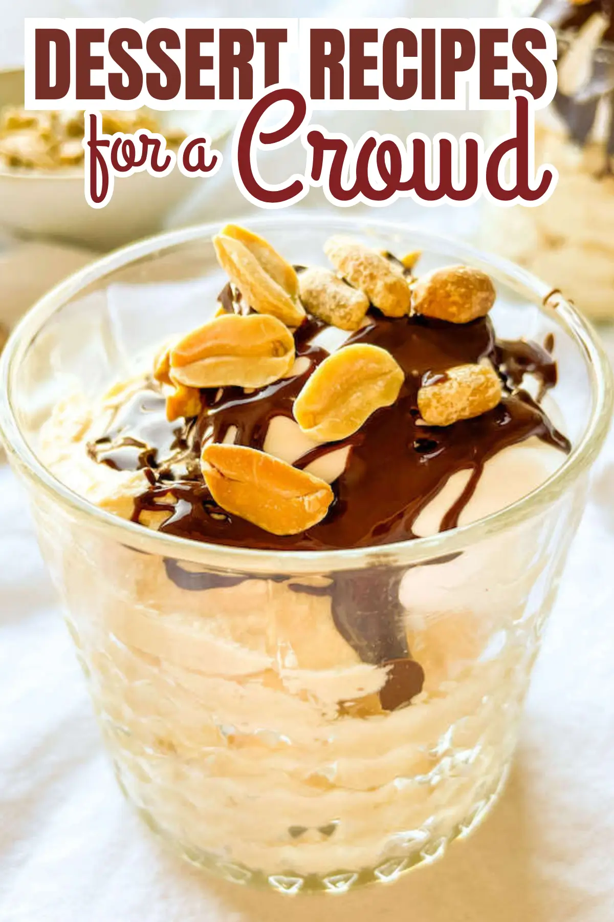 Peanut hot fudge sundae in a glass cup with vanilla ice cream, chocolate sauce, and peanuts; dessert for a crowd