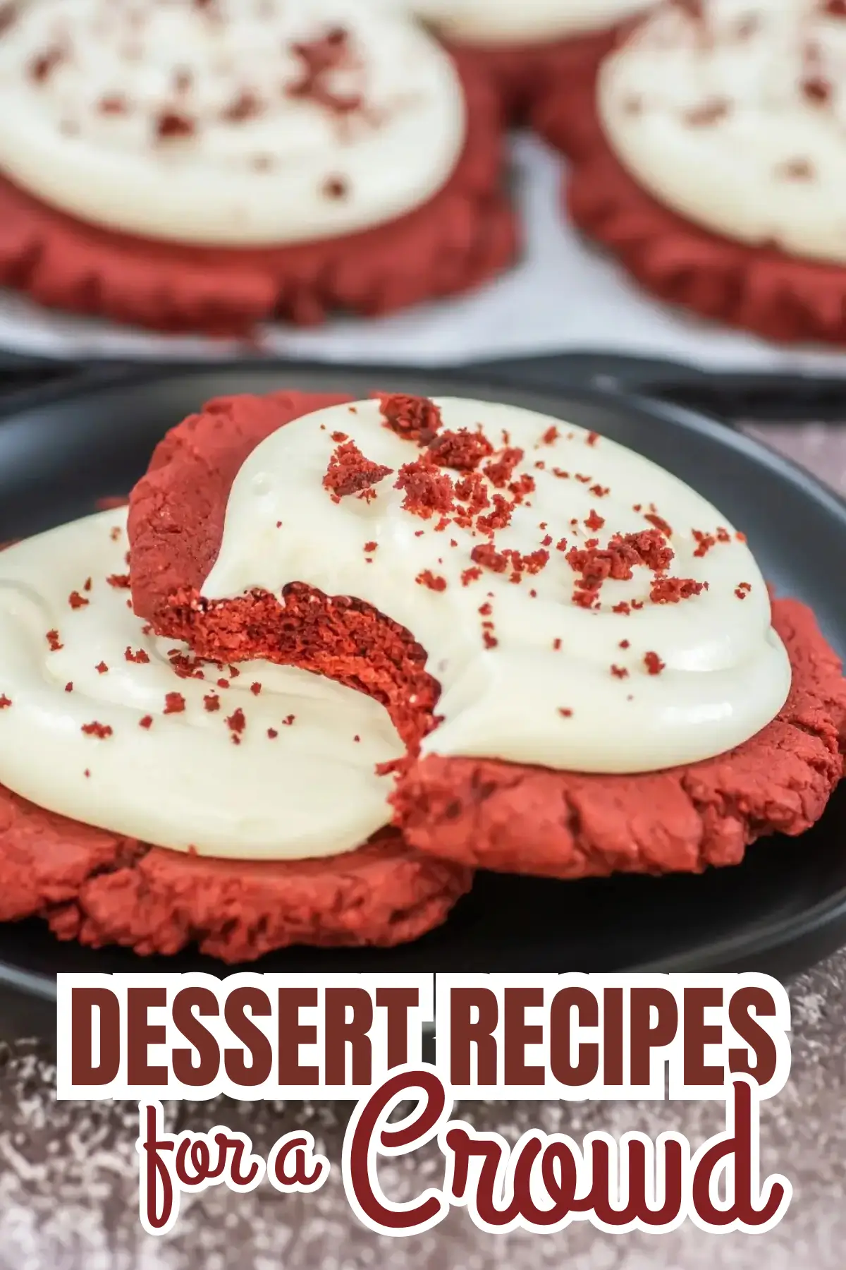 Red velvet cookies topped with cream cheese frosting and crumbs on a plate, perfect for crowds