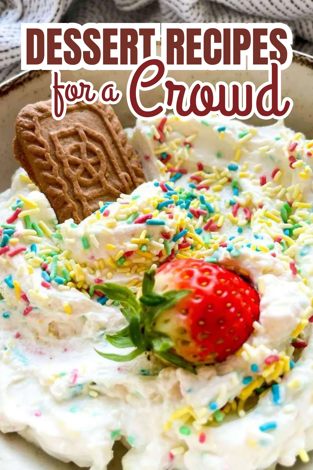 Whipped cream dessert dip with rainbow sprinkles, Biscoff cookie, and fresh strawberry