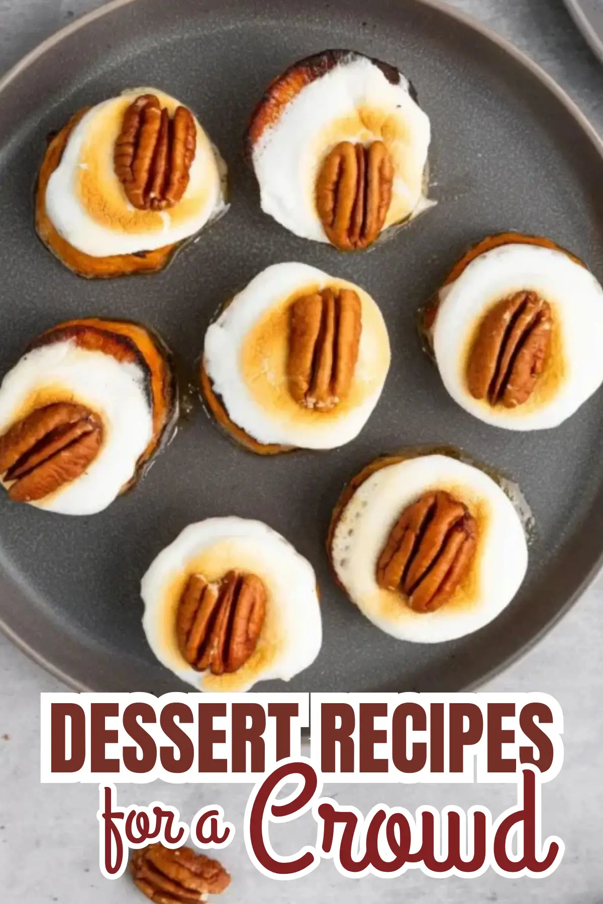 Sweet potato rounds with toasted marshmallow and pecan topping on a plate, dessert for a crowd