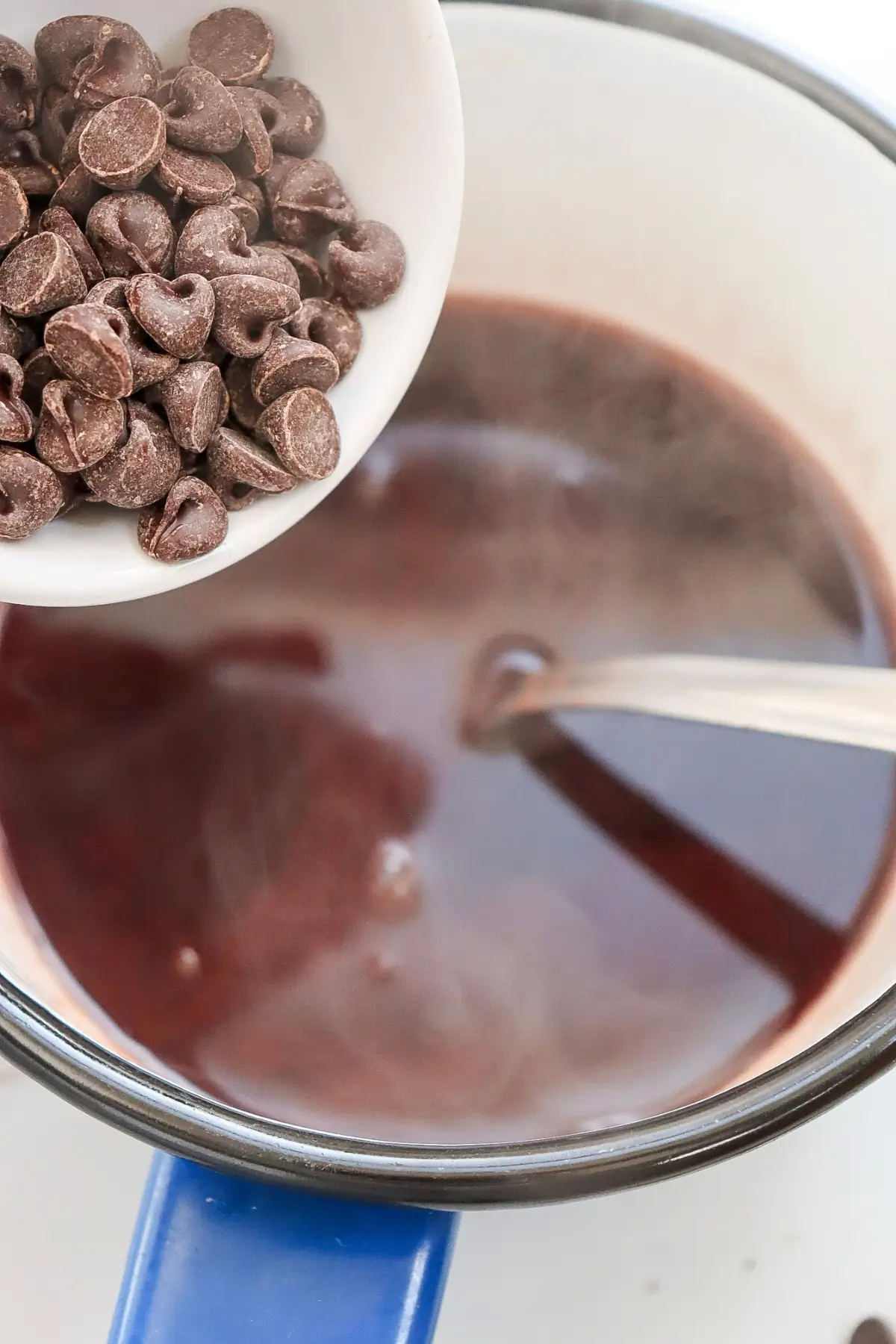 Preparing sugar-free hot chocolate with almond milk.