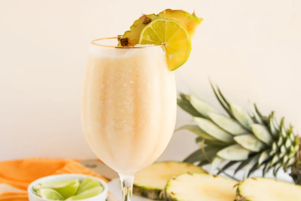 Easy Non Alcoholic Drinks for Parties with Friends Tropical pina colada cocktail with lime and pineapple garnish