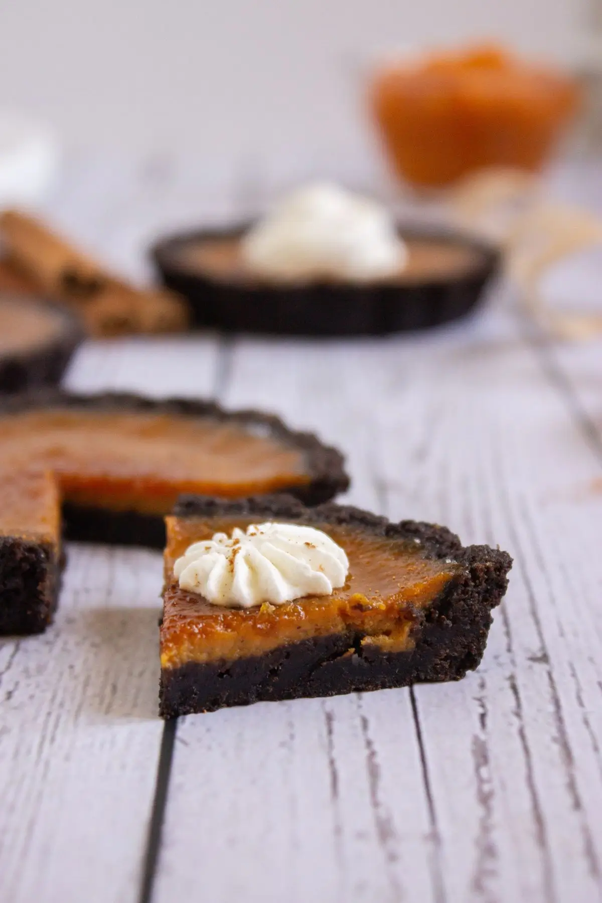 Close-up of sliced pumpkin creme brulee tart showing creamy custard filling and crisp crust, perfect for fall dessert lovers.