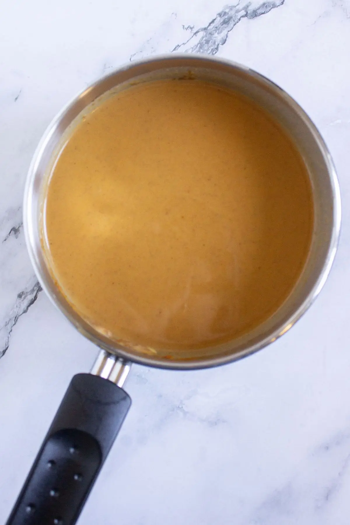Smooth pumpkin custard mixture in saucepan, creamy base for pumpkin tartlets and easy fall desserts with creme brulee flavor