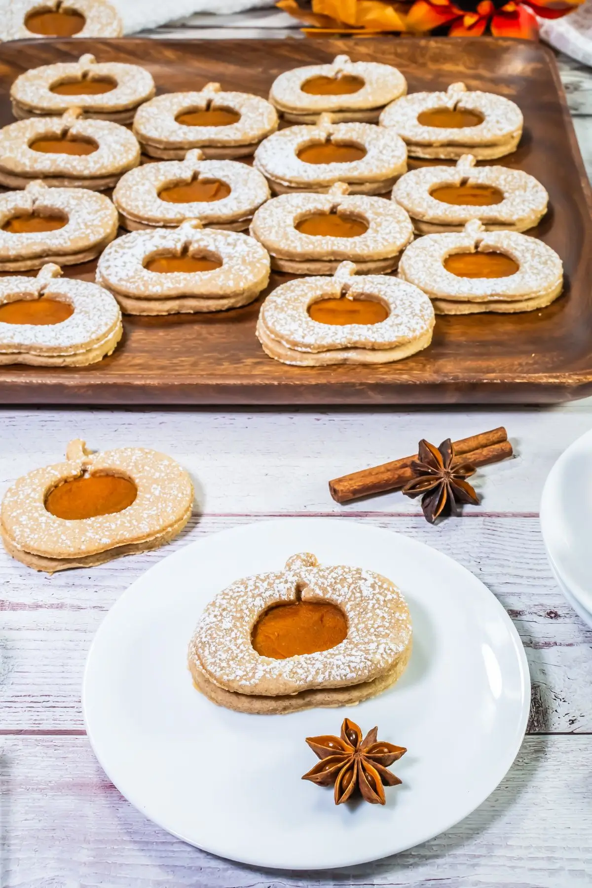The Bestest Pumpkin Linzer Cookies Pumpkin-shaped linzer cookies with pumpkin filling and powdered sugar