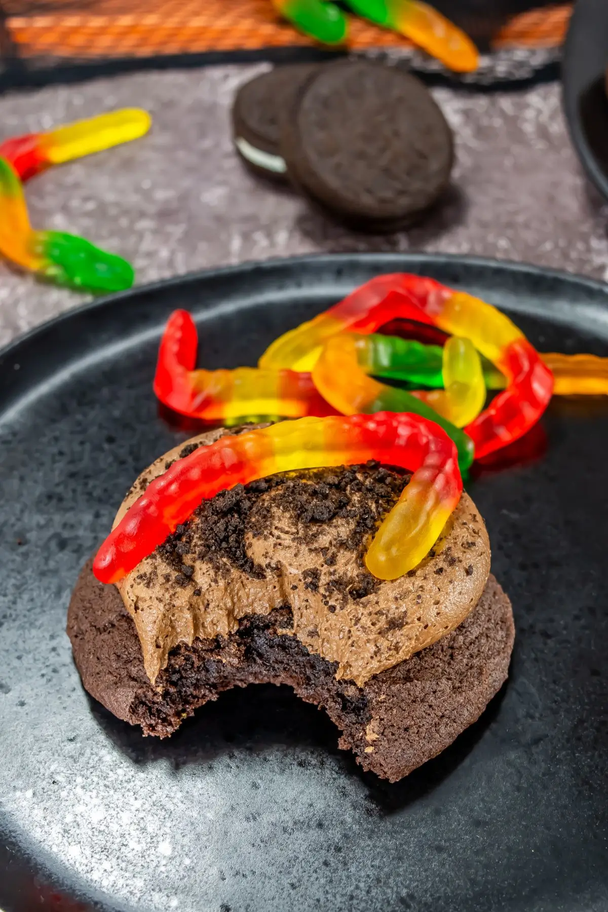 Chocolate dirt cookie with frosting, Oreo crumbs, and gummy worms