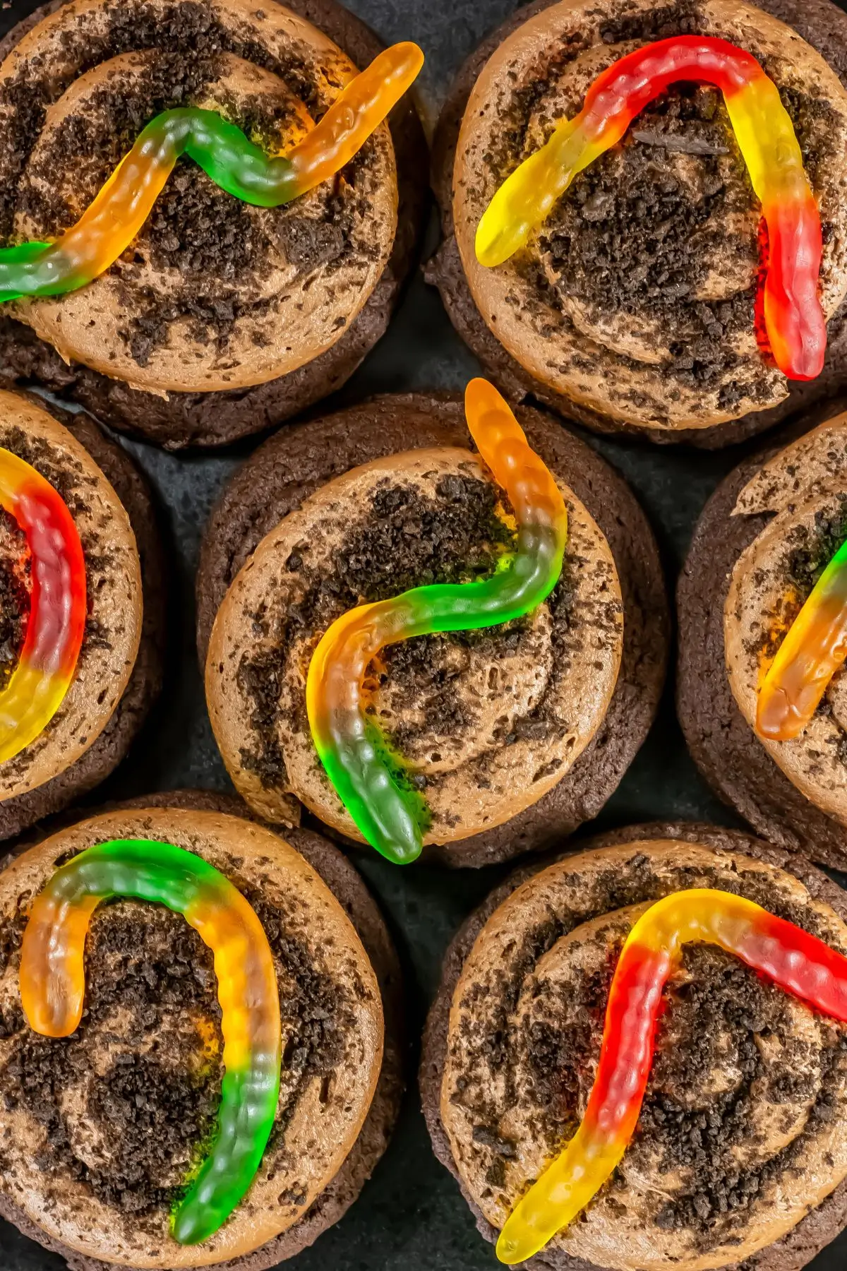 Halloween dirt cookies topped with gummy worms and crushed Oreos