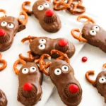 Christmas chocolate reindeer cookies with pretzel antlers and red noses
