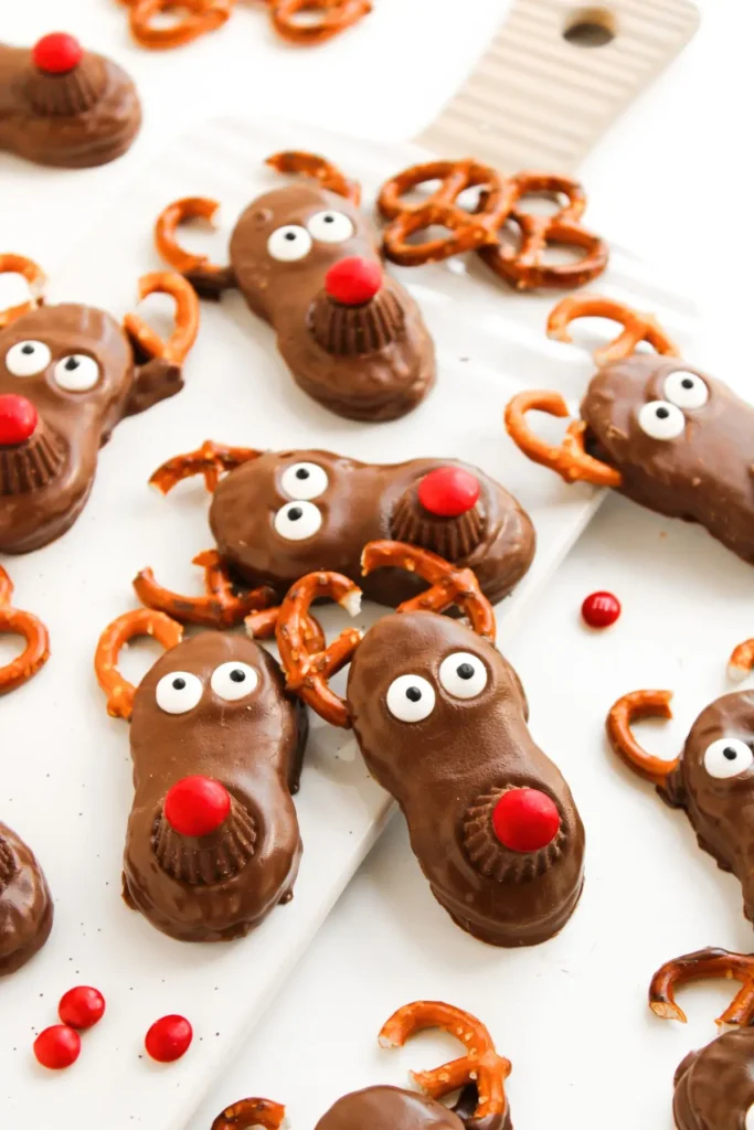Christmas chocolate reindeer cookies with pretzel antlers and red noses