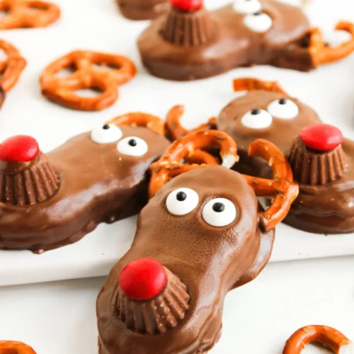 Reindeer Nutter Butter Cookies Christmas chocolate reindeer cookies with pretzel antlers and red noses