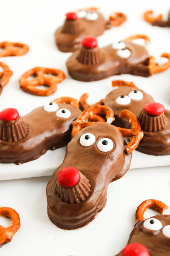 Christmas chocolate reindeer cookies with pretzel antlers and red noses